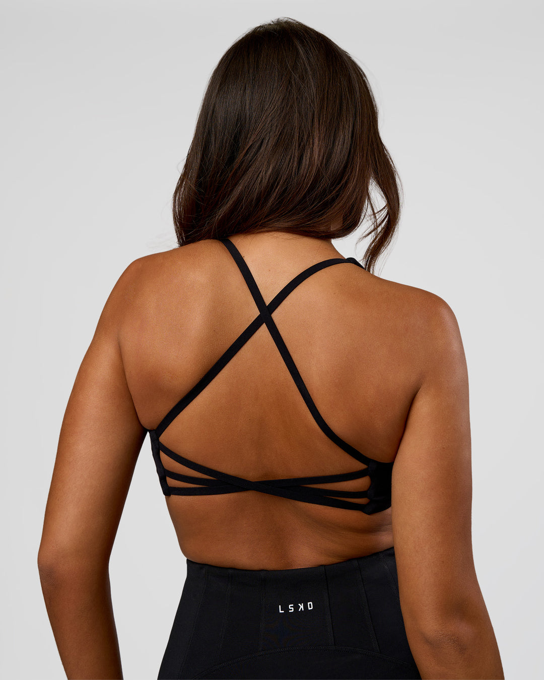Woman wearing Stellar Sports Bra - Black | Model:Kirstyn | Size:S - view 1