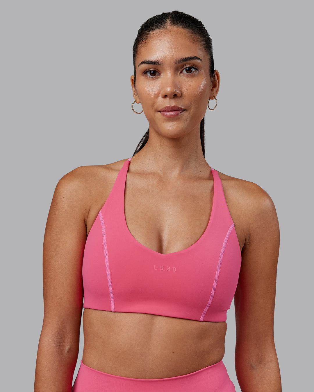 Woman wearing Stellar Sports Bra - Hot Pink | Model:Rhiley | Size:S - view 3