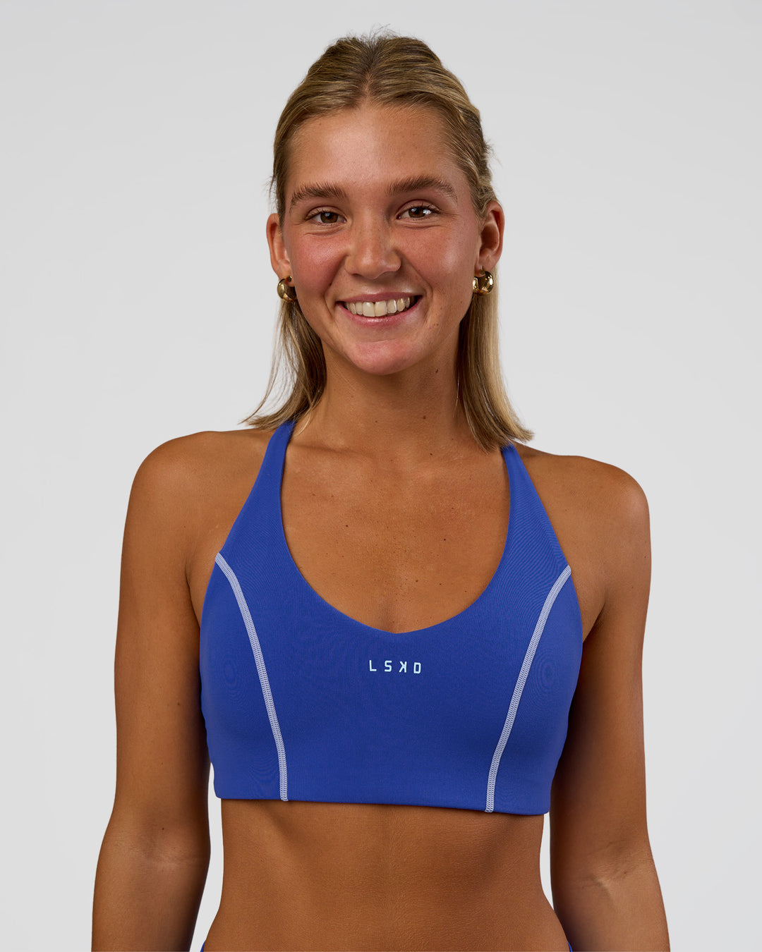 Woman wearing Stellar Sports Bra - Power Cobalt | Model:Amity | Size:S - view 1