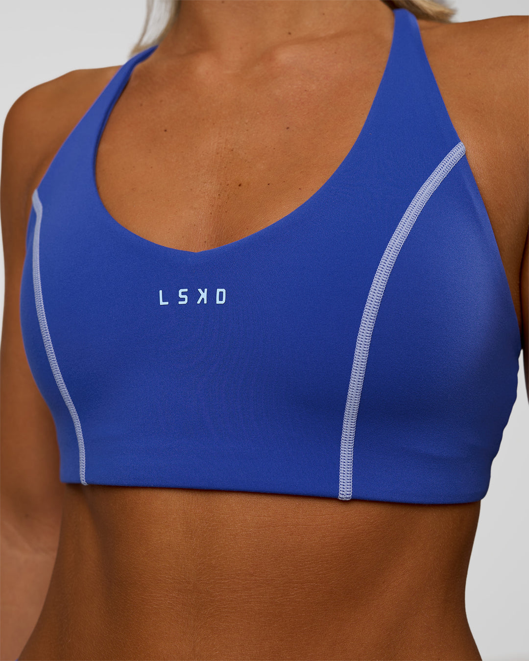 Woman wearing Stellar Sports Bra - Power Cobalt | Model:Amity | Size:S - view 4