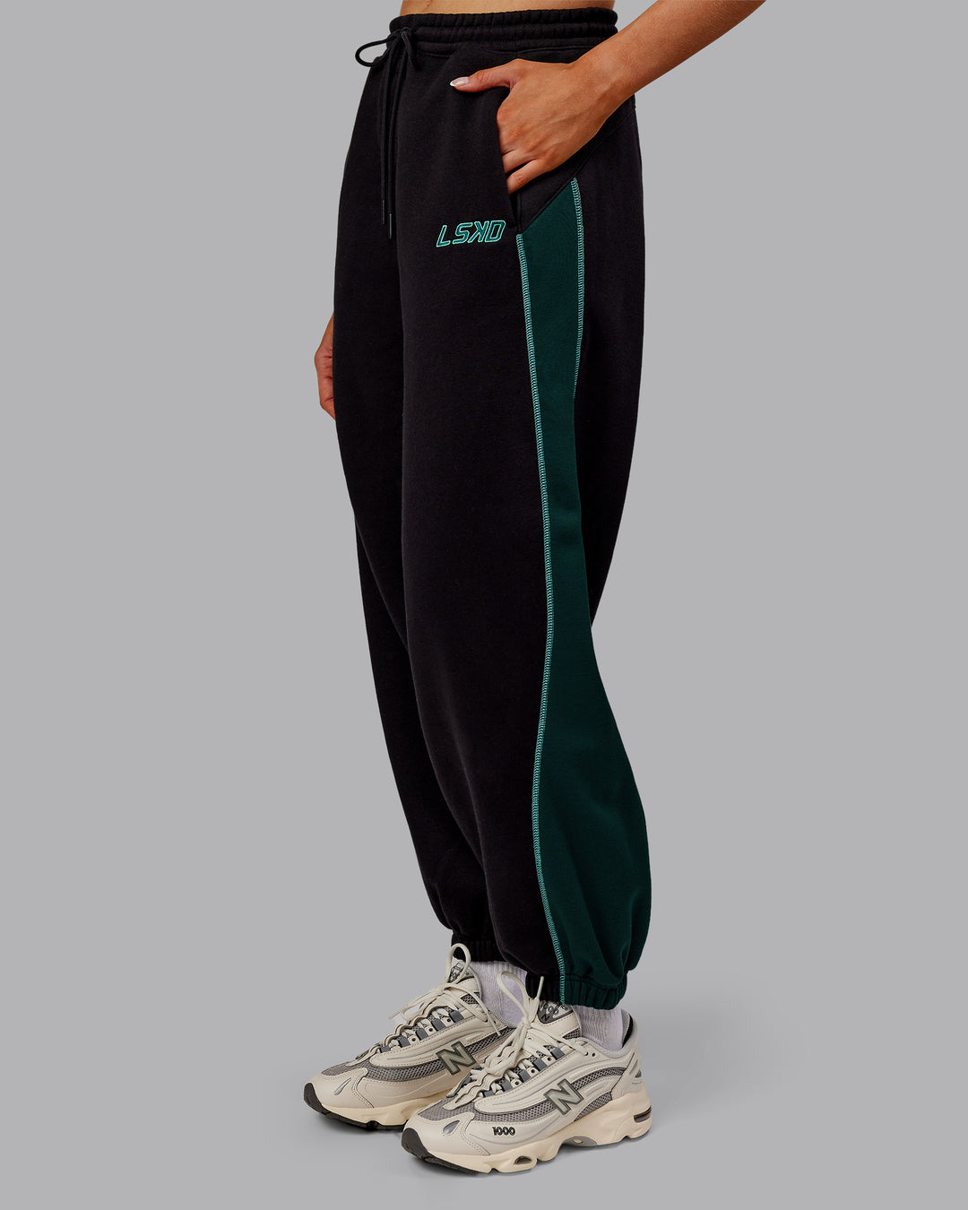 Woman wearing Stitch Up Fleece Sweat Pant - Black/Dark Moss | Model:Ella | Size:S - view 5