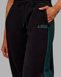 Woman wearing Stitch Up Fleece Sweat Pant - Black/Dark Moss | Model:Ella | Size:S | Thumbnail Index: 6