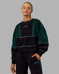 Woman wearing Stitch Up Oversized Fleece Sweater - Black-Dark Moss | Model:Ella | Size:S | Thumbnail Index: 0