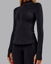 Woman wearing Stride Thermal Zip Through Jacket - Black | Model:Ella | Size:S | Thumbnail Index: 9