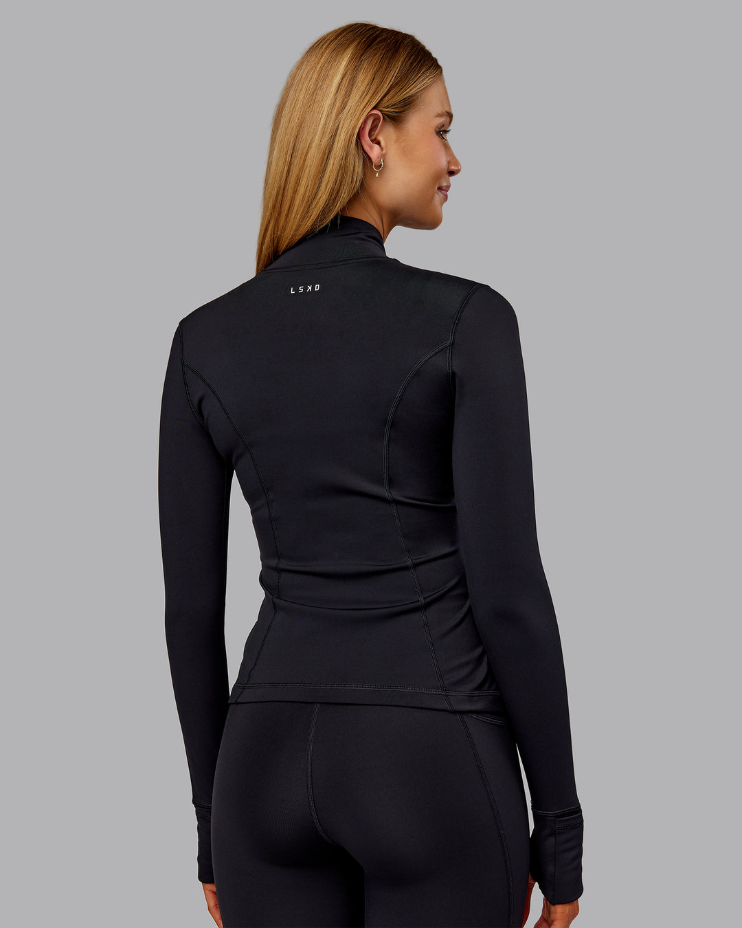 Woman wearing Stride Thermal Zip Through Jacket - Black | Model:Ella | Size:S - view 3