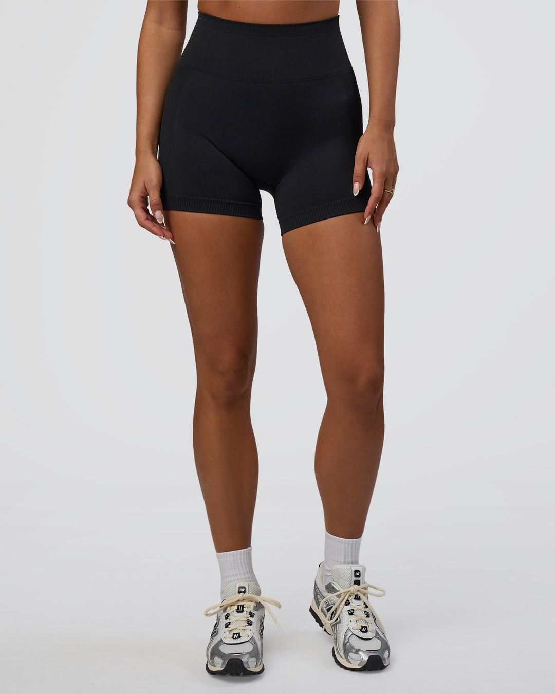 Woman wearing Surge Seamless High-Rise 4" Short - Black | Model:Bianca | Size:S - view 3