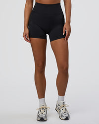 Woman wearing Surge Seamless High-Rise 4" Short - Black | Model:Bianca | Size:S | Thumbnail Index: 2