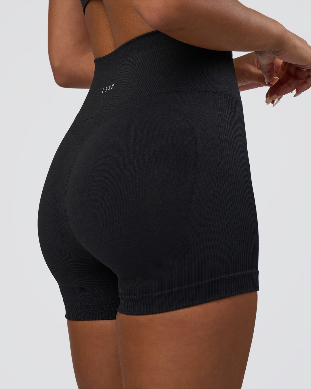 Woman wearing Surge Seamless High-Rise 4" Short - Black | Model:Bianca | Size:S - view 4