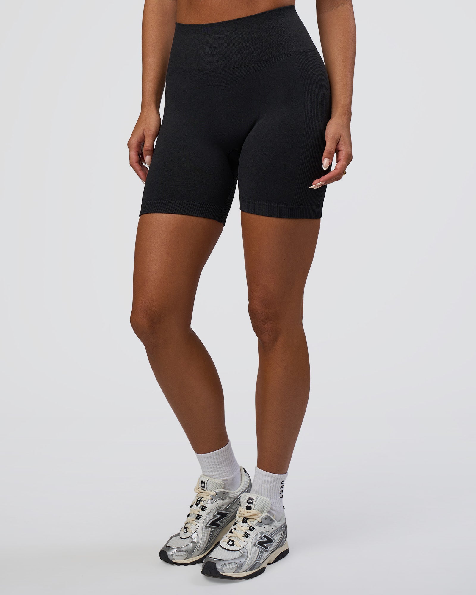 Woman wearing Surge Seamless High-Rise 6" Short - Black | Model:Bianca | Size:S