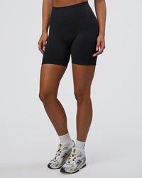 Woman wearing Surge Seamless High-Rise 6" Short - Black | Model:Bianca | Size:S | Thumbnail Index: 0