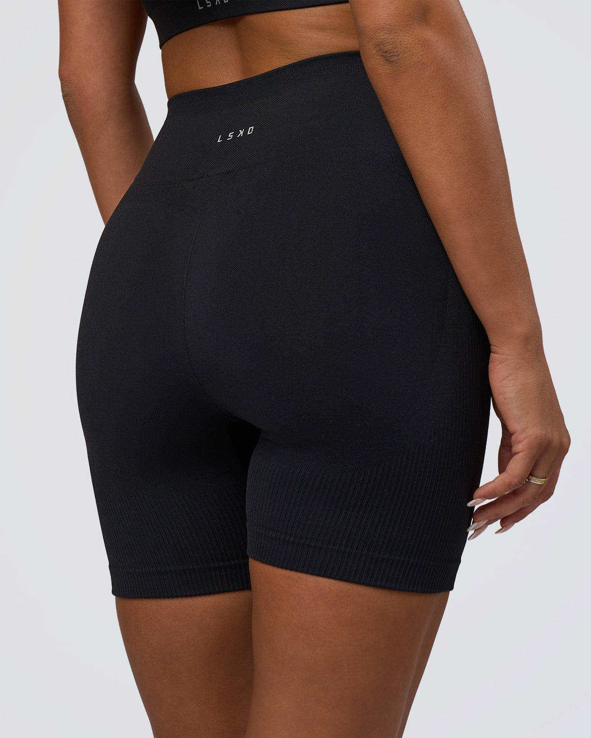 Woman wearing Surge Seamless High-Rise 6" Short - Black | Model:Bianca | Size:S