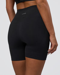 Woman wearing Surge Seamless High-Rise 6" Short - Black | Model:Bianca | Size:S | Thumbnail Index: 1