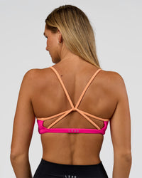 Woman wearing Tempo Sports Bra - Ultra Pink-Cantaloupe | Model:Amity | Size:S | Thumbnail Index: 1