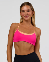 Woman wearing Tempo Sports Bra - Ultra Pink-Cantaloupe | Model:Amity | Size:S | Thumbnail Index: 0