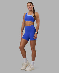 Woman wearing Thrive Asymmetric Sports Bra - Power Cobalt-Open Air | Model:Hannah | Size:S | Thumbnail Index: 3