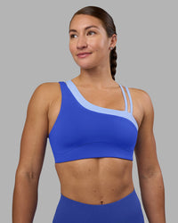 Woman wearing Thrive Asymmetric Sports Bra - Power Cobalt-Open Air | Model:Hannah | Size:S | Thumbnail Index: 1