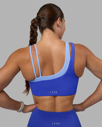 Woman wearing Thrive Asymmetric Sports Bra - Power Cobalt-Open Air | Model:Hannah | Size:S | Thumbnail Index: 7