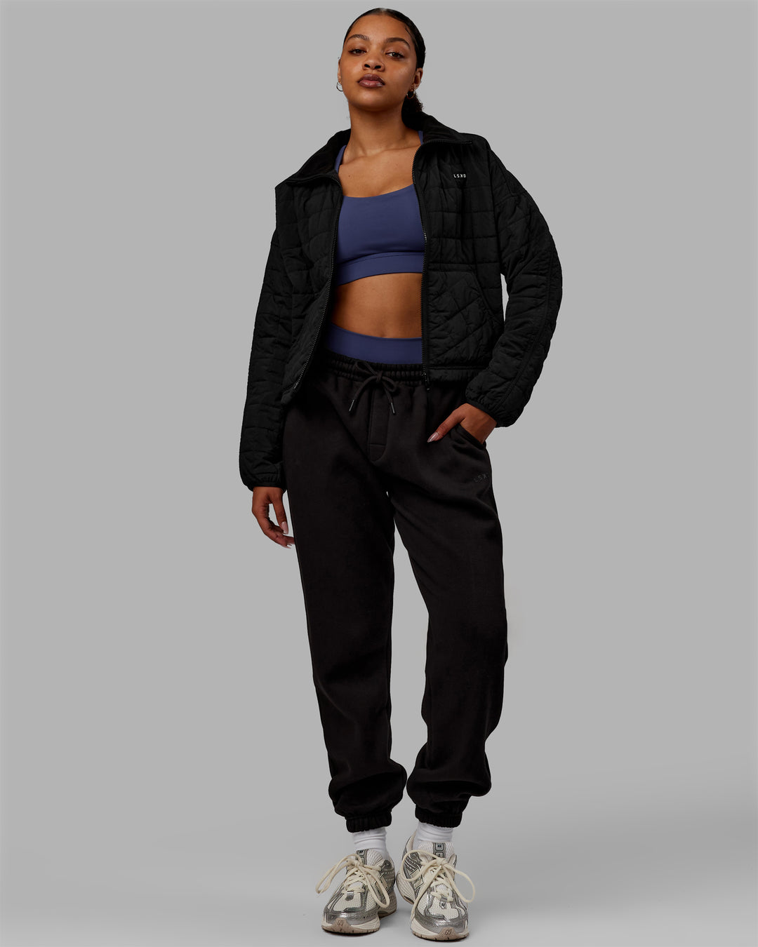 Woman wearing Thrive Packable Jacket - Black - view 8