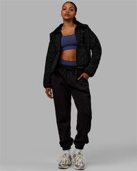 Woman wearing Thrive Packable Jacket - Black | Thumbnail Index: 7