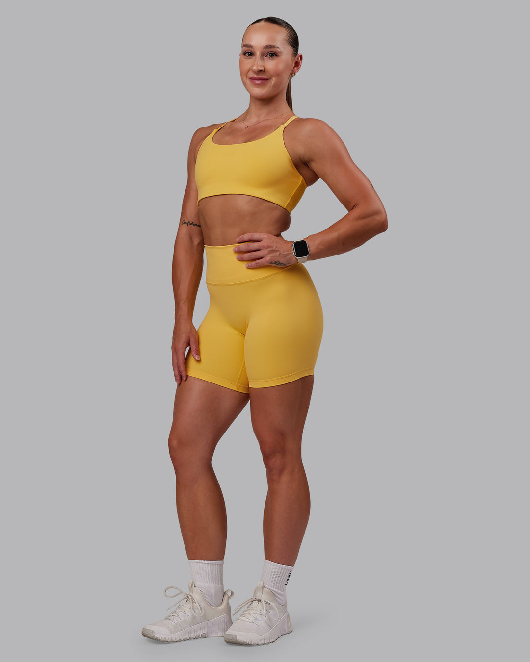Woman wearing Twist Sports Bra in Banana Cream | Size:S - view 8