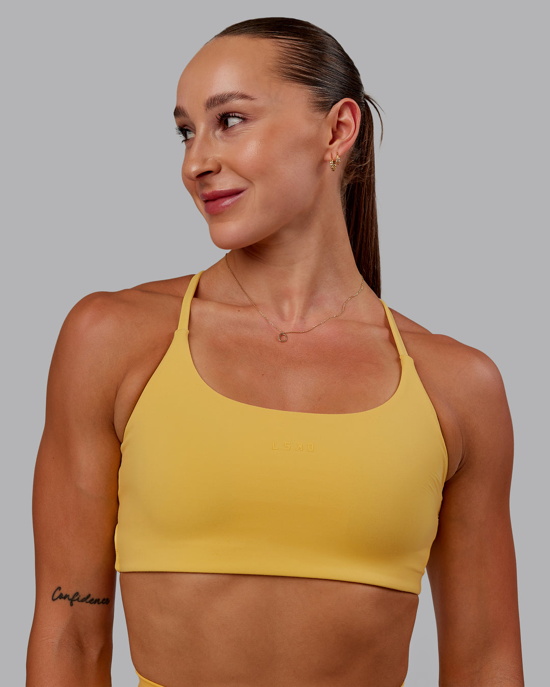 Woman wearing Twist Sports Bra in Banana Cream | Size:S - view 1