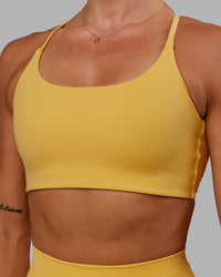 Woman wearing Twist Sports Bra in Banana Cream | Size:S | Thumbnail Index: 6