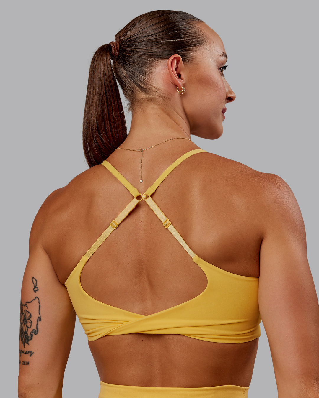 Woman wearing Twist Sports Bra in Banana Cream | Size:S - view 6