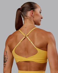 Woman wearing Twist Sports Bra in Banana Cream | Size:S | Thumbnail Index: 5