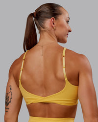 Woman wearing Twist Sports Bra in Banana Cream | Size:S | Thumbnail Index: 3
