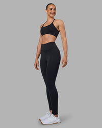 Woman wearing Twist Sports Bra - Black | Model:Sophie | Size:S | Thumbnail Index: 2