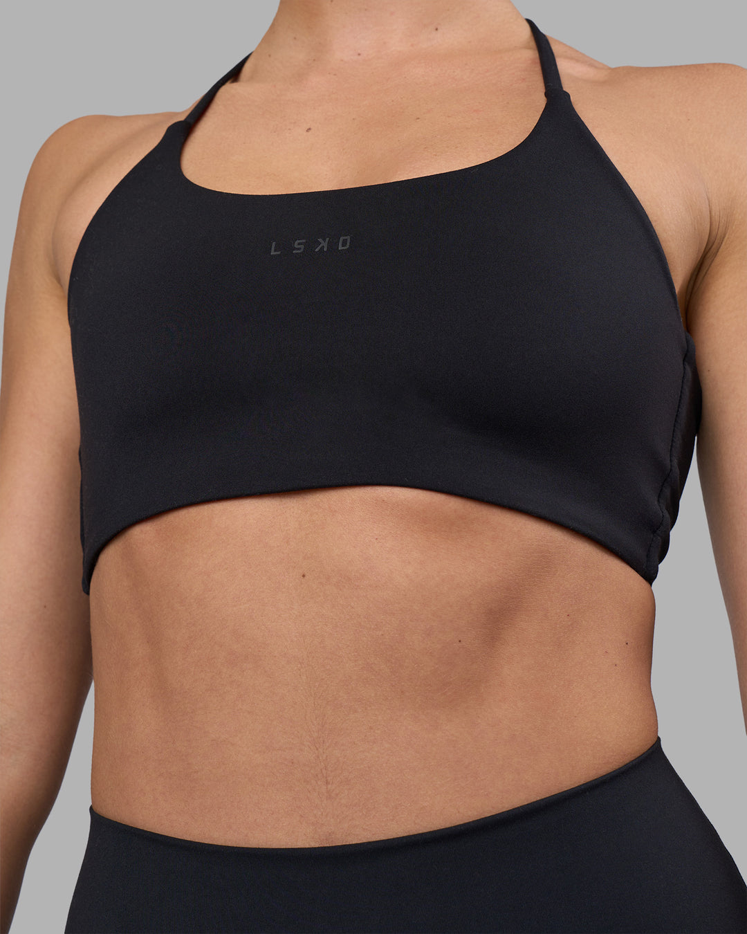 Woman wearing Twist Sports Bra - Black | Model:Sophie | Size:S - view 6