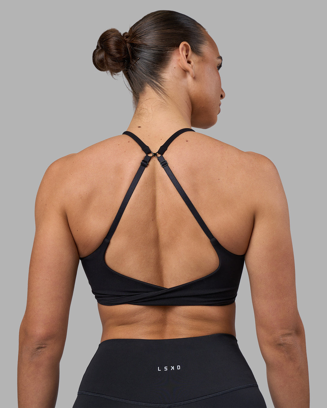 Woman wearing Twist Sports Bra - Black | Model:Sophie | Size:S - view 4