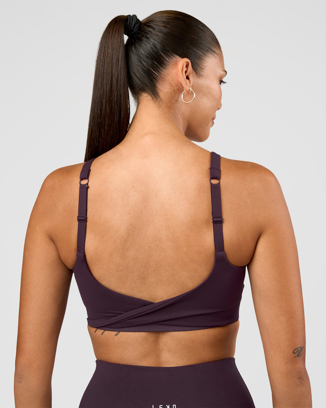 Woman wearing Twist Sports Bra D/DD/E - Midnight Plum | Model:Rhiley | Size:S - view 2