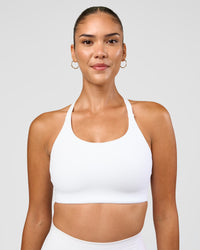 Woman wearing Twist Sports Bra D/DD/E - White | Model:Rhiley | Size:S | Thumbnail Index: 0