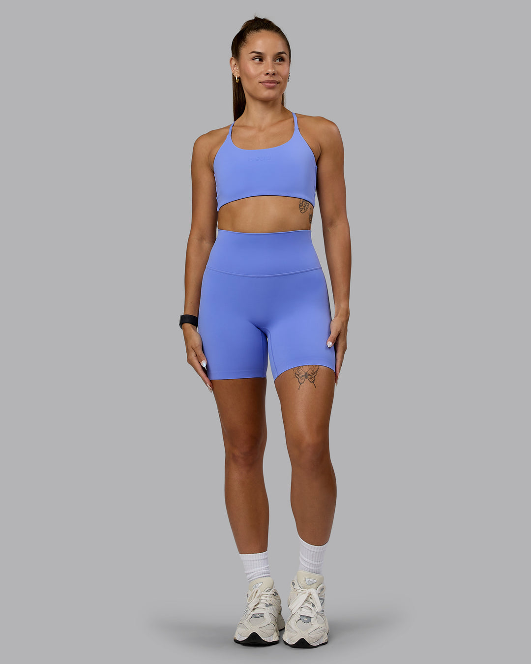 Woman wearing Twist Sports Bra - Indulgent Blue - view 7