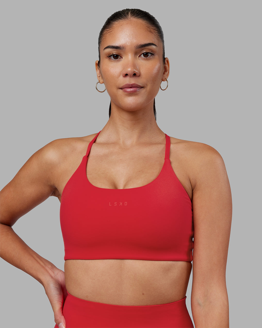 Woman wearing Twist Sports Bra - Scarlet | Model:Rhiley | Size:S - view 1