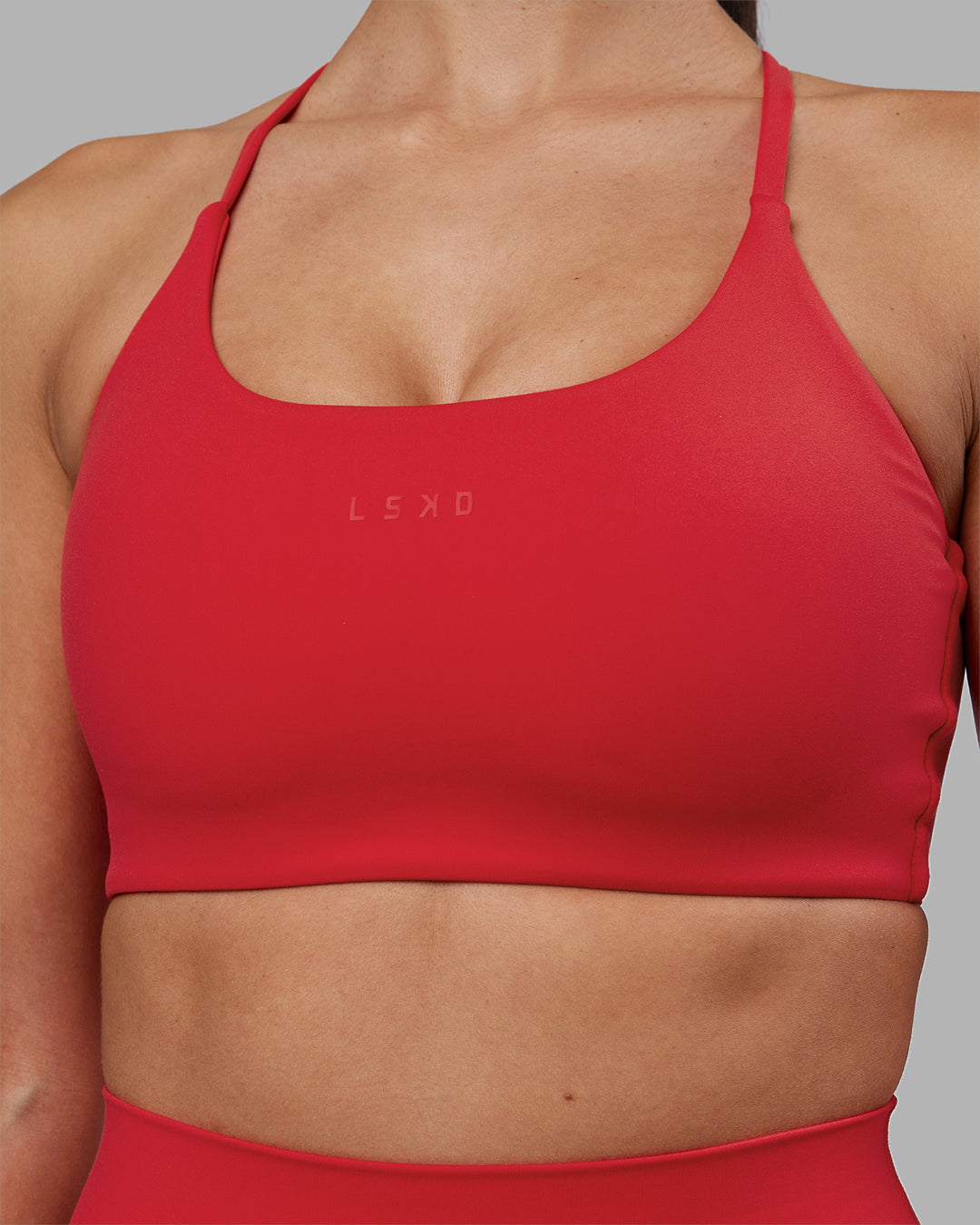 Woman wearing Twist Sports Bra - Scarlet | Model:Rhiley | Size:S - view 4