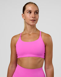 Woman wearing Twist Sports Bra - Ultra Fuchsia | Model:Myrte | Size:S | Thumbnail Index: 0