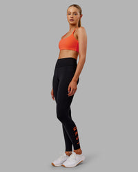 Woman wearing Twist Sports Bra - Ultra Orange | Model:Ella | Size:S | Thumbnail Index: 4