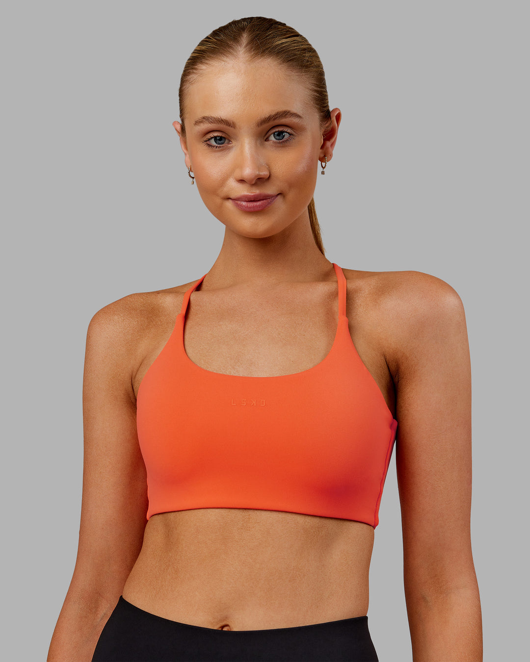 Woman wearing Twist Sports Bra - Ultra Orange | Model:Ella | Size:S - view 3