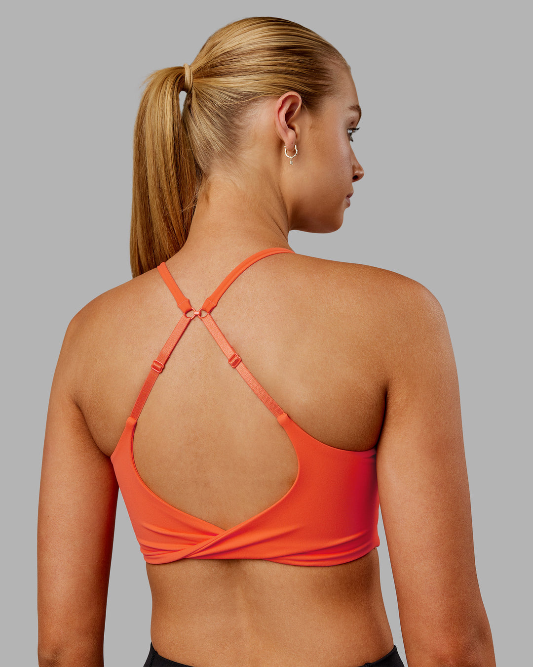 Woman wearing Twist Sports Bra - Ultra Orange | Model:Ella | Size:S - view 1