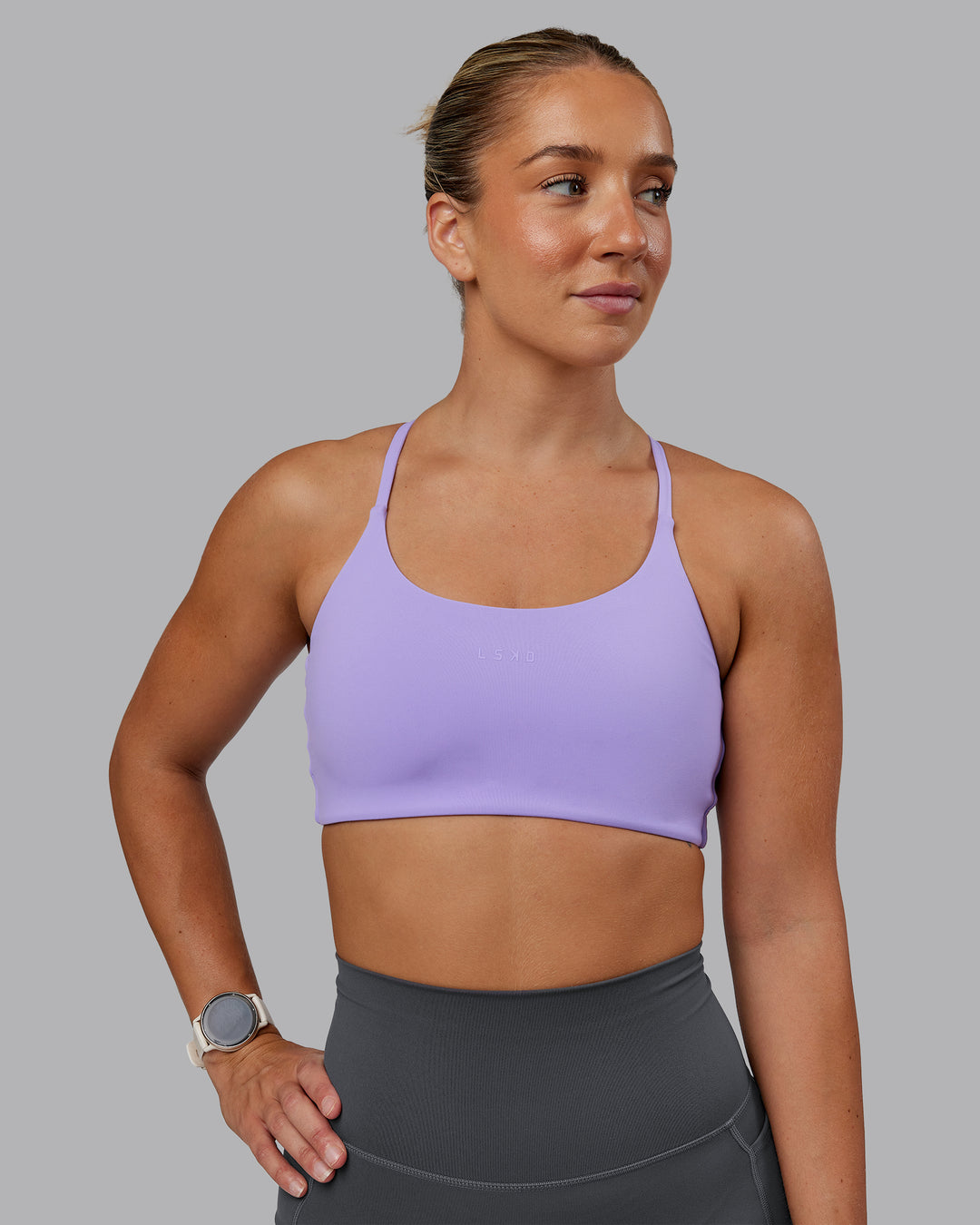 Woman wearing Twist Sports Bra in Violet Ray | Size:S - view 2