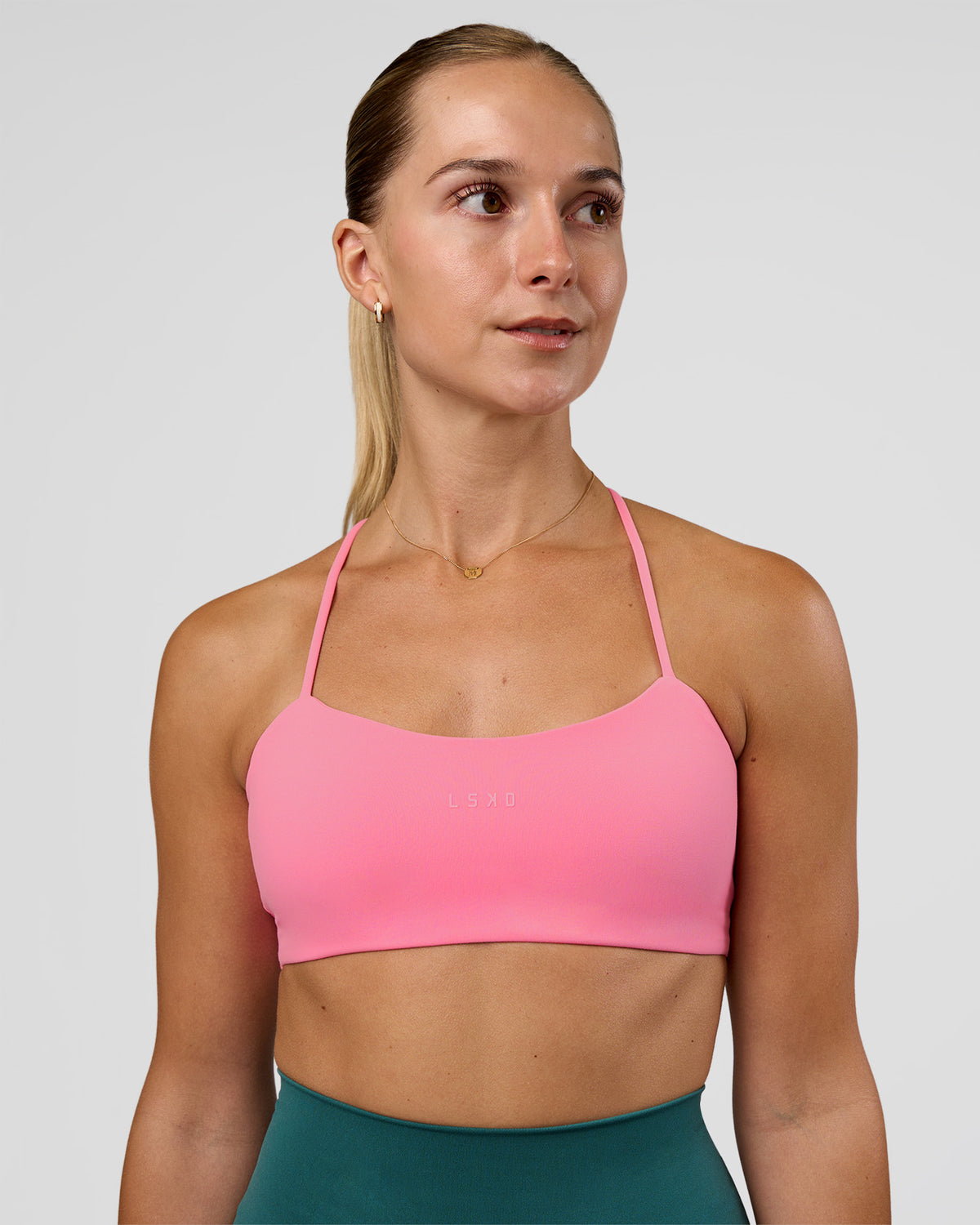 Woman wearing Twister Sports Bra - Candy Pink | Model:Myrte | Size:S