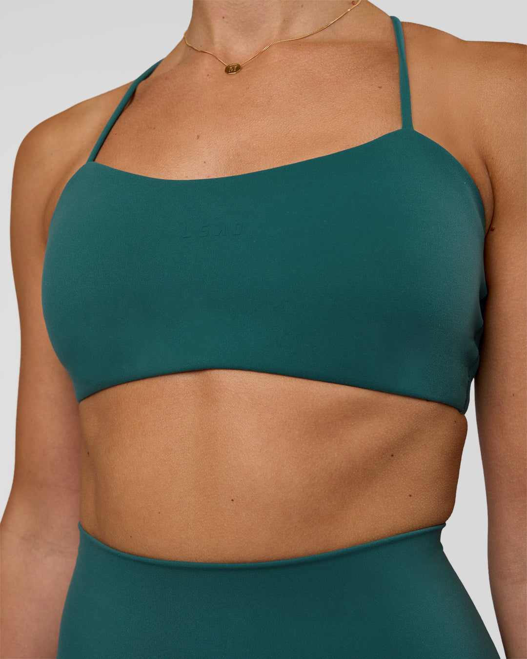 Woman wearing Twister Sports Bra - Transformative Teal | Model:Myrte | Size:S - view 3