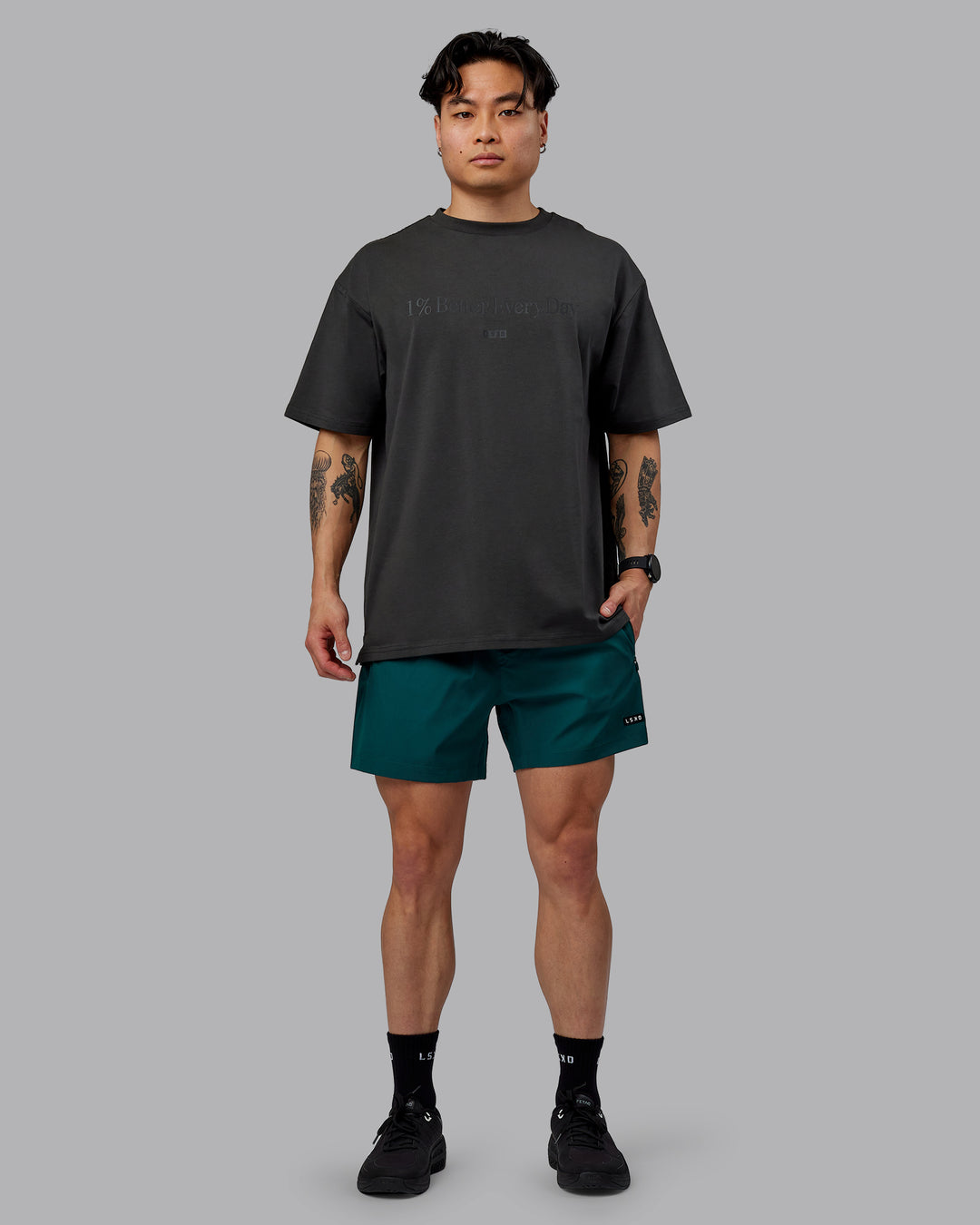 Man wearing Unisex 1% Better FLXCotton Tee Oversize - Pirate Black-Black - view 10