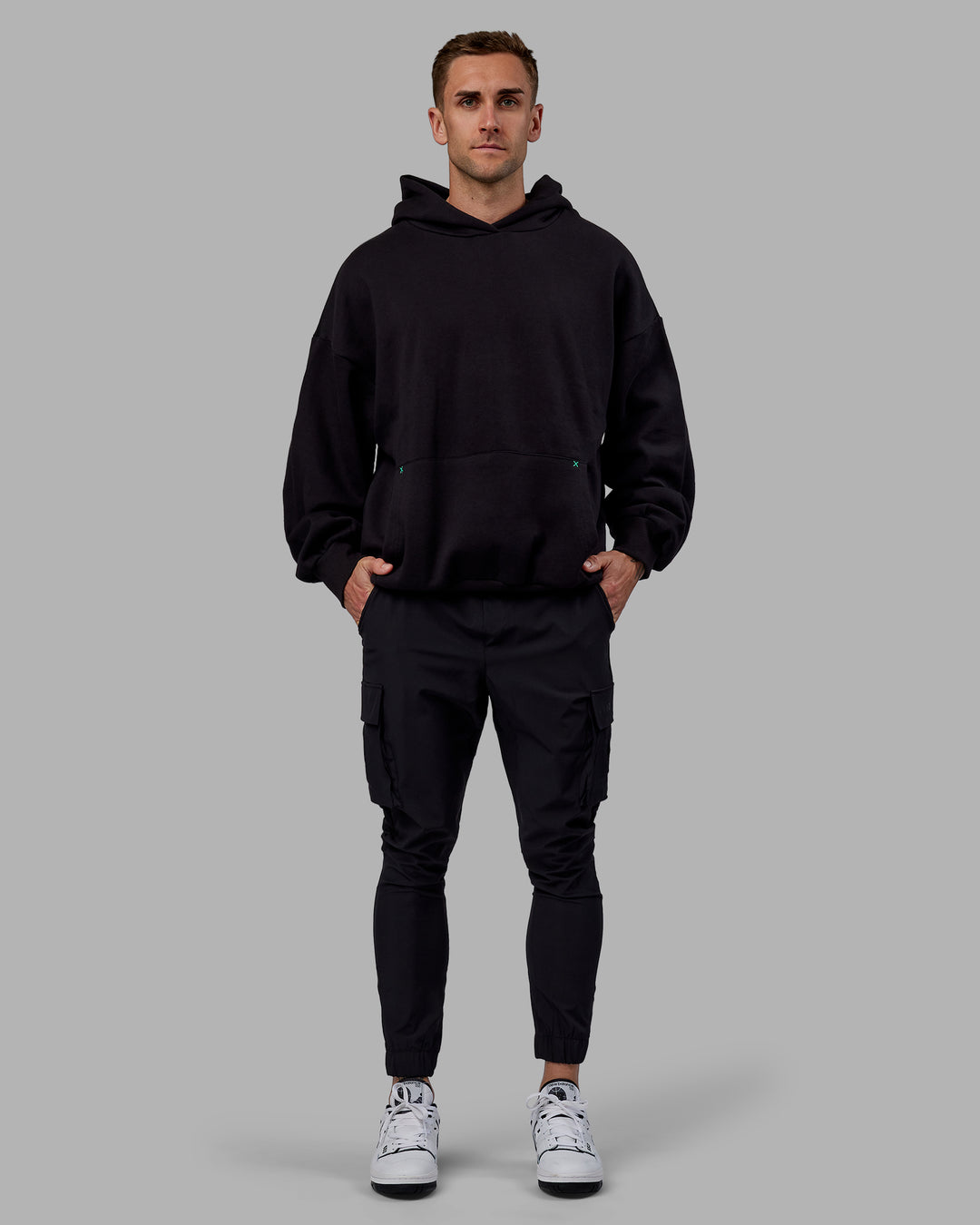 Man wearing Unisex We Rise Hoodie Oversize - Black-Impact Green - view 9