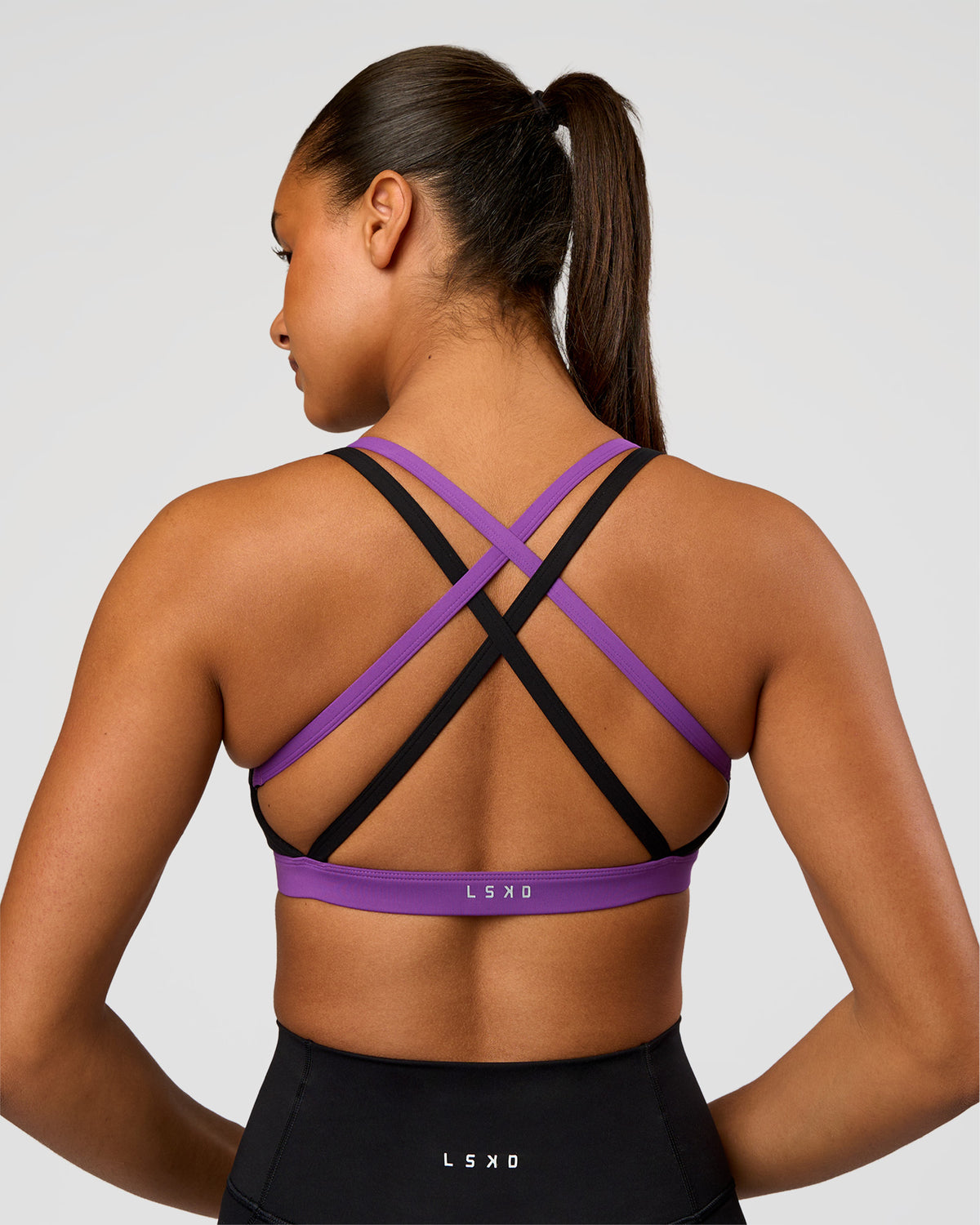 Woman wearing Velocity Graphic Sports Bra - Black-Radiate | Model:Rosie | Size:S