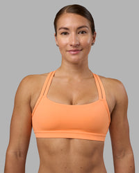 Woman wearing Velocity Sports Bra - Cantaloupe | Model:Hannah | Size:S | Thumbnail Index: 1