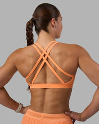 Woman wearing Velocity Sports Bra - Cantaloupe | Model:Hannah | Size:S | Thumbnail Index: 0