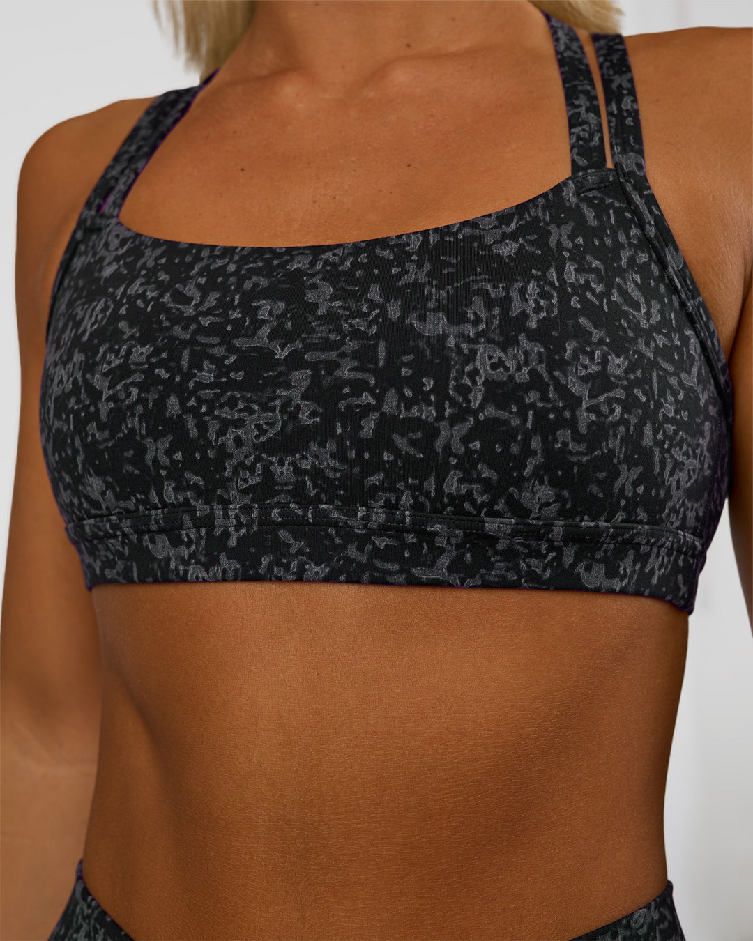 Woman wearing Velocity Sports Bra - Energy Print Black | Model:Amity | Size:S - view 4